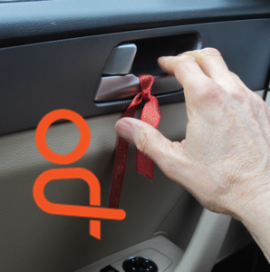 Far hand to latch with reminder ribbon, with Dutch Reach icon.