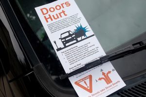 Driver reeducation flier placed under windshield wiper of parked cars, Orange St, New Haven, CT in 2013; advises 'Amsterdam method.'