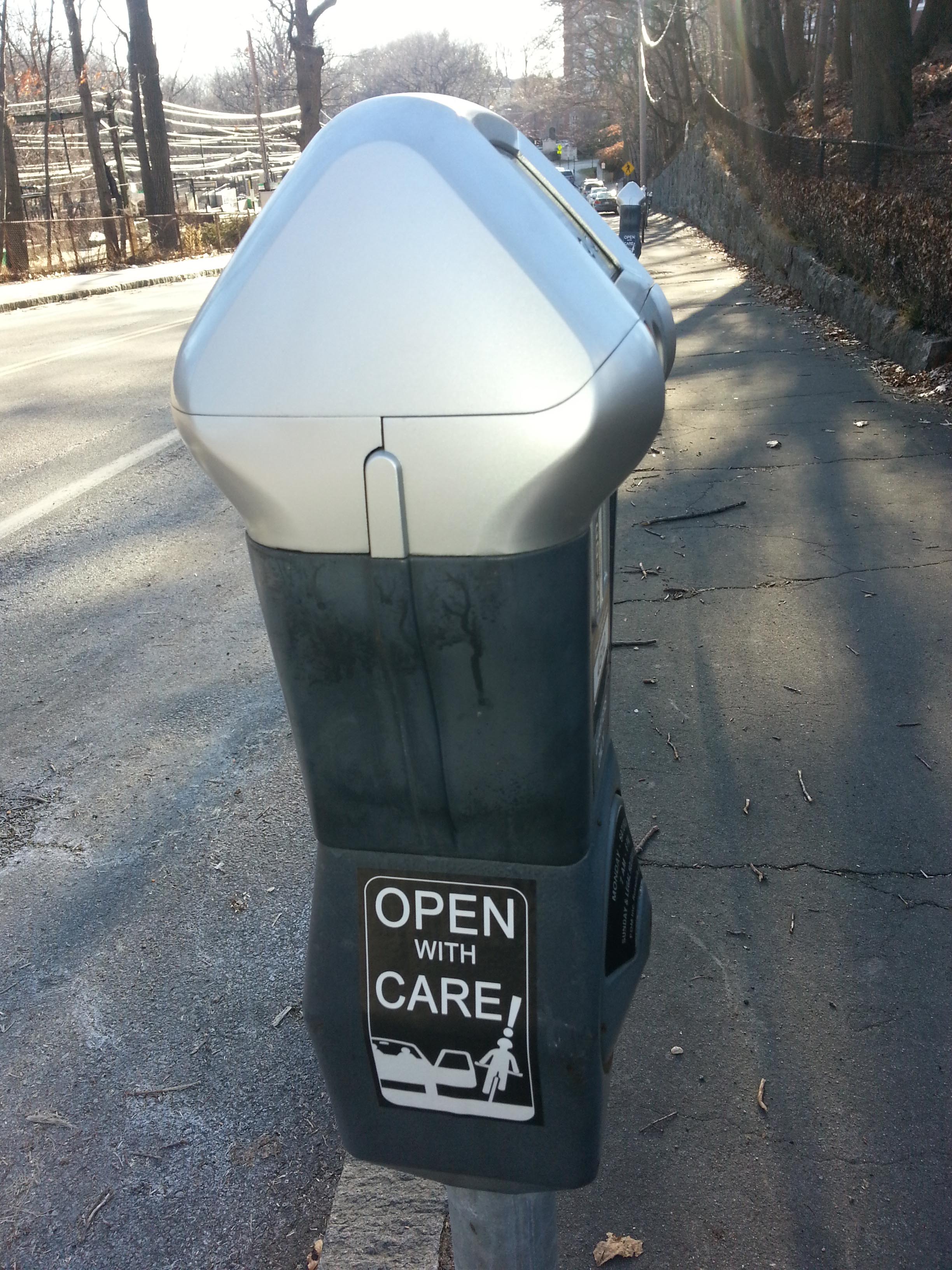 Anti dooring sticker on parking meter, Brookline, MA, USA - 2016. Unknown bike safety activists "vandalized" meters in Boston, Cambridge, Brookline & possibly elsewhere with "Open With Care" advice. Click image to enlarge.