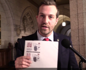 Canadian MP Joel Lightbound displays bilingual Dutch Reach educational outreach card to teach the far hand anti dooring method.