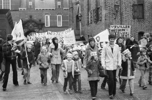 Parents & children marching in streets calling for an end to the violence caused by motorized vehicles.